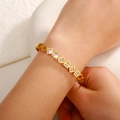 Close-up of golden geometric bangle with square-cut crystal stones on wrist - Square Geometric Open Style (SZ-003)