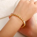 Polished gold-plated open bangle with baguette-cut zircon inlay for women - Baguette Cut Row Rhinestone Style (SZ-004)