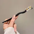 Elegant wavy black wood hair pin featuring white floral accents for traditional styling - Double Flower Hair Stick