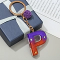 Letter P initial keychain with purple gradient resin, gold stars, and soft pompom charm - Letter P