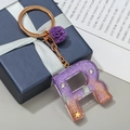 Letter R keychain with purple shell glitter resin and decorative gold star sequins - Letter R
