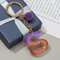 Purple and orange gradient resin letter S keychain with glitter and purple pompom - S