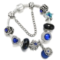 Close-up of blue glass beads and celestial charms on a silver snake chain bracelet - Style 010