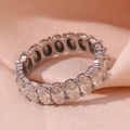 Silver oval cut eternity ring with sparkling stones on beige silk fabric background - US 6 / White Zirconia Steel Color