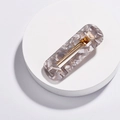 Macro detail of rectangle acrylic hair clip with grey marble texture and gold metal grip - Rectangular Gray Style (H01_3)