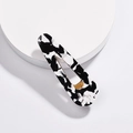 Detailed macro view of large teardrop hair clip with black and white marble acetate finish - Water Drop Cow Print Style (H02_1)