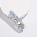 Macro detail of blue marble texture acetate hair clip with golden metal fastener - Blue Water Drop Style (H02_2)