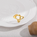 Detail shot of a minimalist irregular hollow gold ring on a textured ceramic plate - Rhombus Plain Style