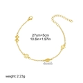 Detail of 18K gold plated steel chain with bow and star charms showing 27cm length - Compass Star Style