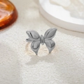 Macro shot of polished silver butterfly ring with high-gloss metallic finish texture - Silver Plain Bow Style