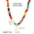 Macro detail of rainbow beads with gold heart and V initial pendant on 14k necklace - Style V(T1506_22)