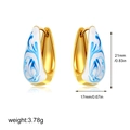 Macro shot of 18K gold hoop earrings with blue and white enamel marble texture detail - Hand-painted Blue and White Porcelain Hoop (Style 2)