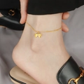 Elegant 18K gold plated bow anklet for women on model with stylish leather sandals - Bowknot Style / Gold