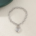 Detail shot of silver chunky chain bracelet featuring a heart pendant and toggle clasp - Bracelet / Silver