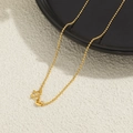 Close-up of 24K gold-plated beaded chain with W-clasp on a modern black and white backdrop - Bead Chain / Gold