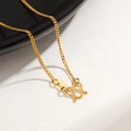 Macro view of 24K gold-plated titanium steel curb chain with classic M-shaped clasp - Curb Chain / Gold
