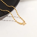 Macro detail of 24K gold-plated oval bead chain with traditional M-shaped clasp closure - Rice Pearl Necklace / Gold