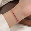 Detailed close-up of woven red rope bracelet with silver steel beads on wrist - Steel Color Red String