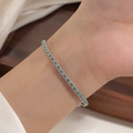 Detail of red woven bracelet with gold titanium steel beads on woman's wrist - Steel Color Green String