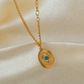 Macro detail of gold oval necklace with blue turquoise stone on champagne silk background - Sunburst Blue Stone Oval Pendant (GX2442) / Gold