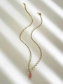 Gold necklace featuring a pink rectangular natural stone pendant on a dainty chain - Watermelon red