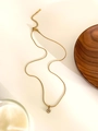 Detail of a gold stainless steel necklace featuring a four-petal flower zircon pendant - Gold Color Four Diamonds