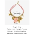 Collana in pizzo rosa con ciondoli a forma di stella marina e conchiglia dorati - Oro