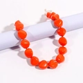 Macro view of orange irregular resin bead necklace with golden metal lobster clasp detail - Orange