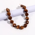 Detailed view of irregular amber-style resin beads with gold lobster clasp and chain - Brown