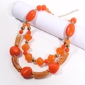 Detail of chunky double-layer beaded necklace in orange and marbled brown with gold chain - KC Gold / Orange