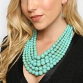 Bohemian multi-layer turquoise bead necklace and earring set shown on model - Green