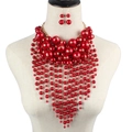 Detailed close-up of red multi-layer beaded fringe statement necklace and earring set - Red