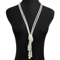 Detail of multilayer long pearl tassel necklace on a black mannequin, vintage style - Double Layer Woven Style (10725)