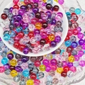 Macro shot of colorful 8mm transparent glass beads for DIY bracelet and necklace making - Multicolor