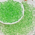 Macro detail of 8mm translucent green glass beads with smooth finish for jewelry making - Light Green