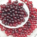 Macro shot of deep red 8mm round glass beads for handmade jewelry DIY projects - Vermilion