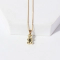 Macro view of gold dainty chain necklace featuring a glossy 3D teddy bear pendant - Gold