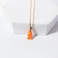 Golden fine chain necklace featuring a cute translucent orange gummy bear pendant charm - Orange