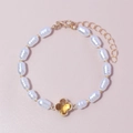 Vintage pearl bracelet with gold hardware and a yellow glass clover-shaped charm - Yellow