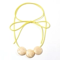 Neon yellow cord necklace featuring three cream resin marble textured circular charms - Yellow