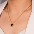 Golden heart necklace featuring a faceted black zircon stone on model neck - Black (Heart 2215)