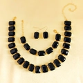 Close-up of rhinestone necklace set with black rectangular gems and golden finish - Black