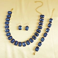 Detail view of gold-tone jewelry set featuring emerald-cut navy blue rhinestones - Blue