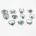 Flat lay of 11-piece bohemian silver rings set featuring turquoise stones and tribal carvings - Turquoise Ring Collection (F23890)