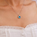 Silver necklace with square pendant and blue zircon stone shown on a female model - Sky Blue Square Gemstone Necklace (A1229)