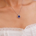 Silver square pendant necklace with deep blue zircon in a classic halo design on model - Deep Blue Square Gemstone Necklace (A1233)