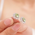 Silver-tone hexagonal halo stud earrings with oval light green gemstone and white zircons - Light Green Zirconia Stud Earrings (A1227)