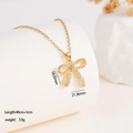 Bow pendant necklace in 18K gold finish with pave zircon stones on a white stand - Bowknot (1660)