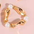 Detail of elegant gold-tone twisted metal bracelet with three lustrous white pearls - Pearl Irregular Metal Ring Bracelet (NK27200)