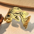 Detailed close-up of 18K gold leaf-shaped open cuff bracelet with hollow vein texture - Leaf Style (SS-YS110-2)